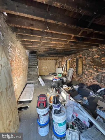 a room with water heater and wooden cabinets