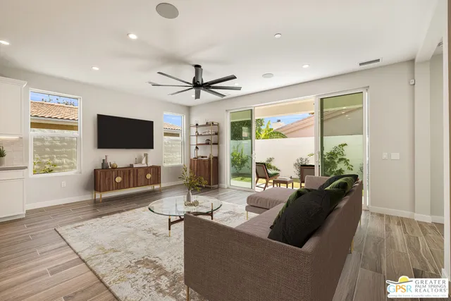 a view of a chairs and table in the backyard of the house