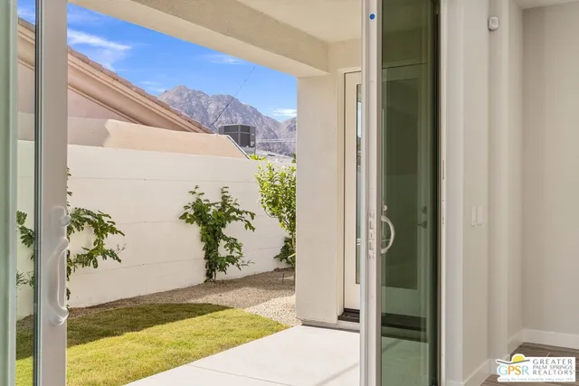 a dining room with furniture potted plants and wooden floor
