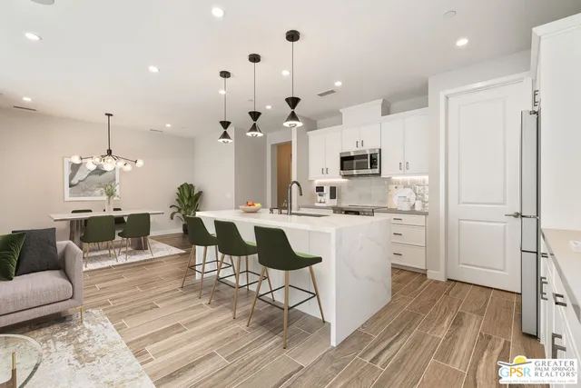 a kitchen with a sink stainless steel appliances and cabinets