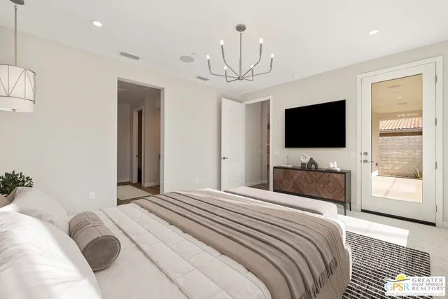 a en suite bathroom with a granite countertop sink and a mirror