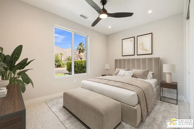 a bedroom with a bed and ceiling fan