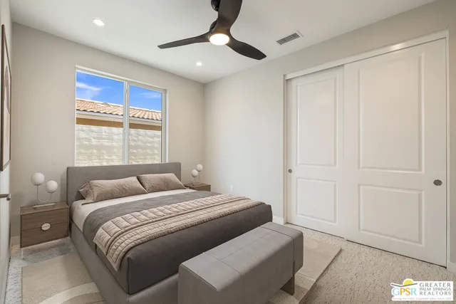 a bedroom with a large bed and a chandelier