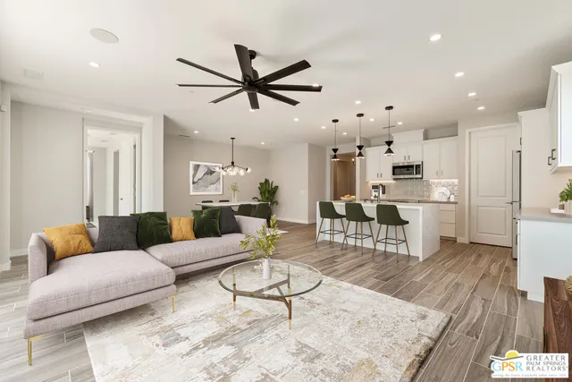 a living room with furniture and kitchen view