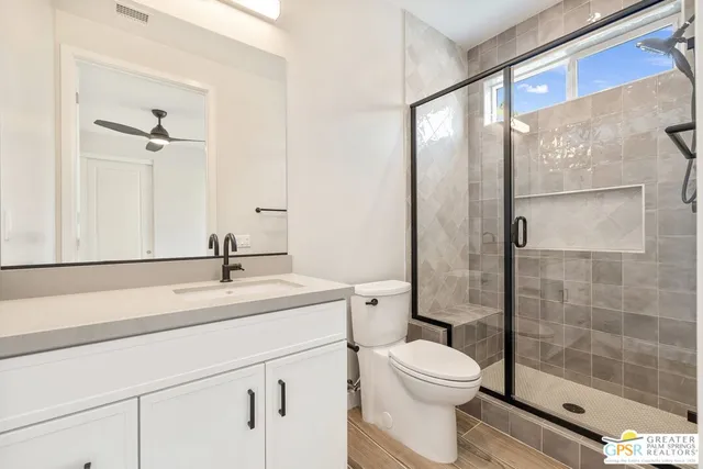 a bedroom with a balcony a bed and a dresser