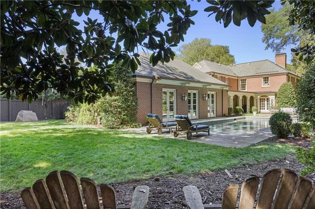 an aerial view of a house with swimming pool garden and patio