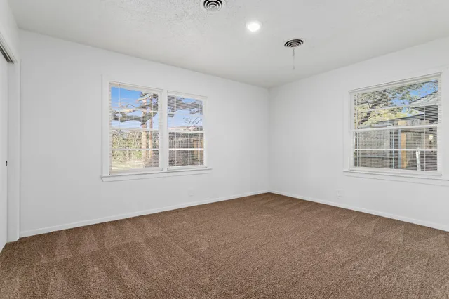 a view of an empty room with windows