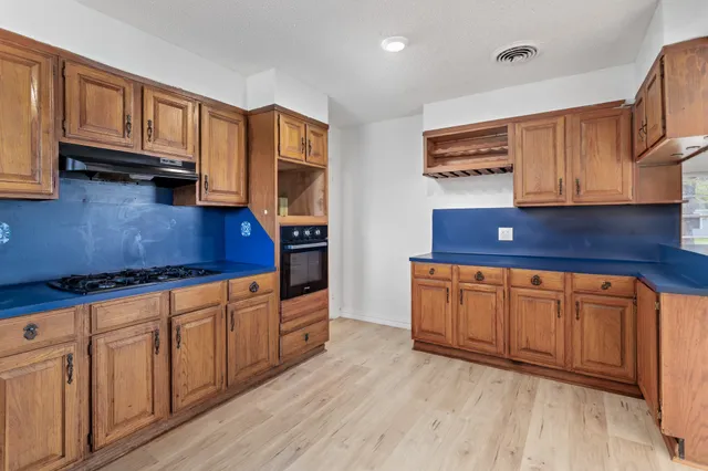 a kitchen with stainless steel appliances granite countertop wooden cabinets a sink and dishwasher