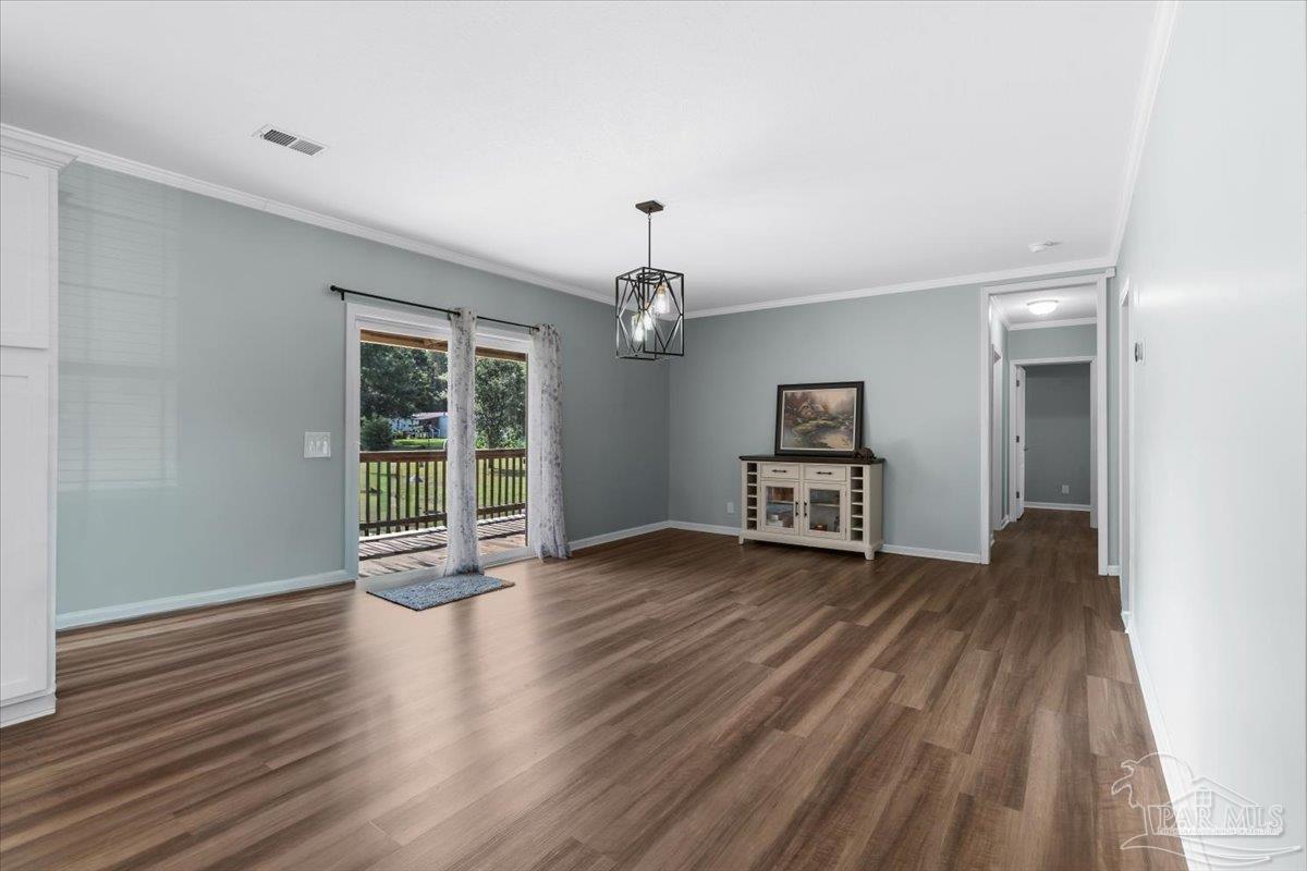 4955 Blue Ribbon Drive Milton, FL 32583 - Photo 5 of 32 wooden floor in an empty room with a window
