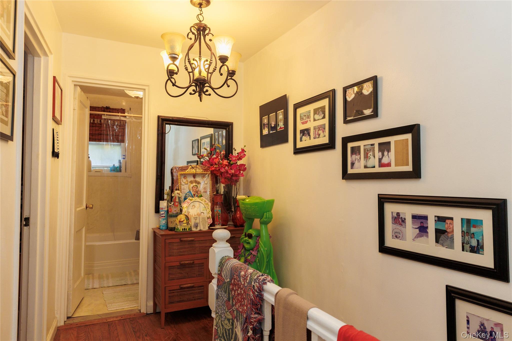 2440 Morgan Avenue Bronx, NY 10469 - Photo 16 of 23 Corridor with a chandelier and dark wood finished floors