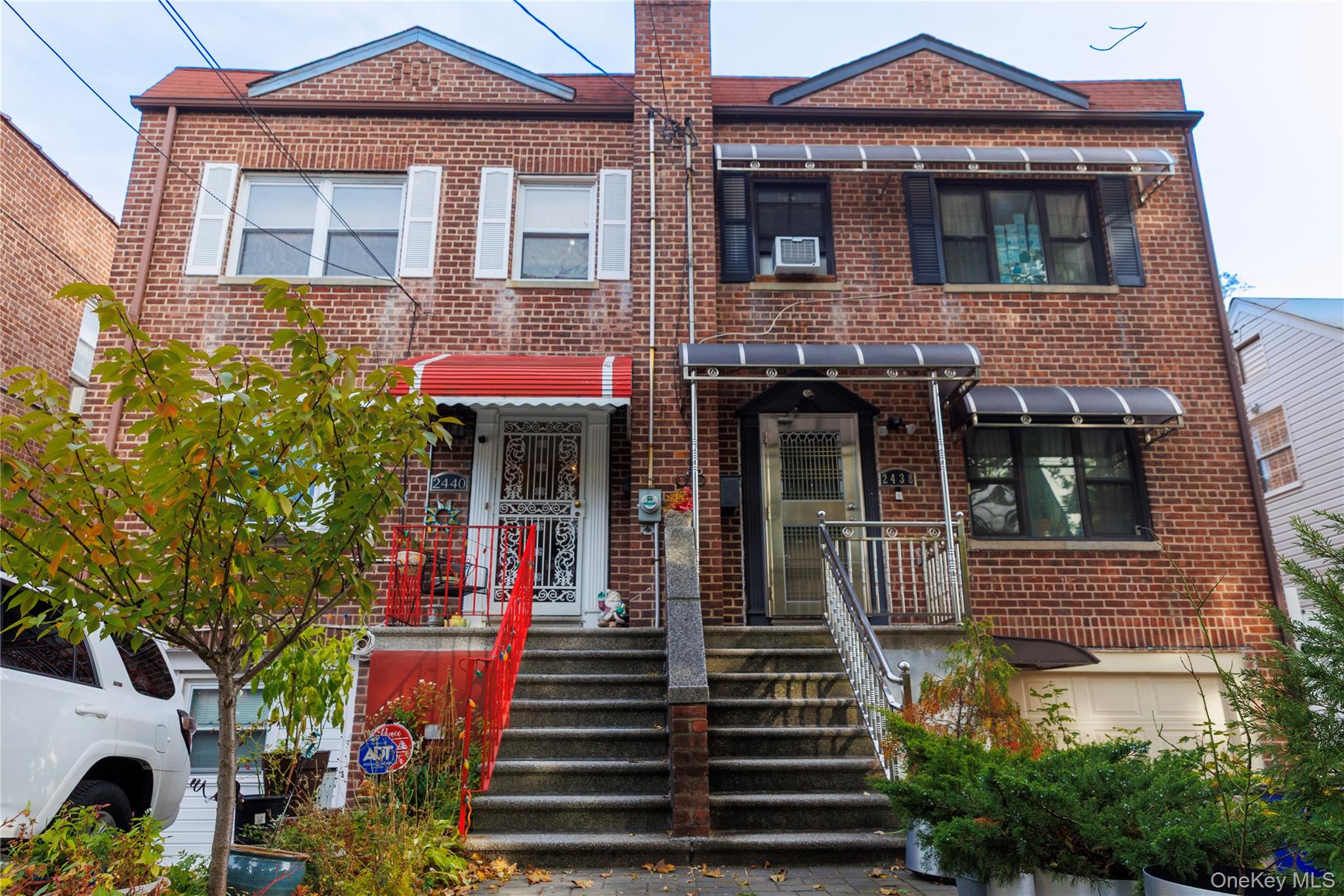 2440 Morgan Avenue Bronx, NY 10469 - Photo 3 of 23 Traditional-style home featuring brick siding and a chimney