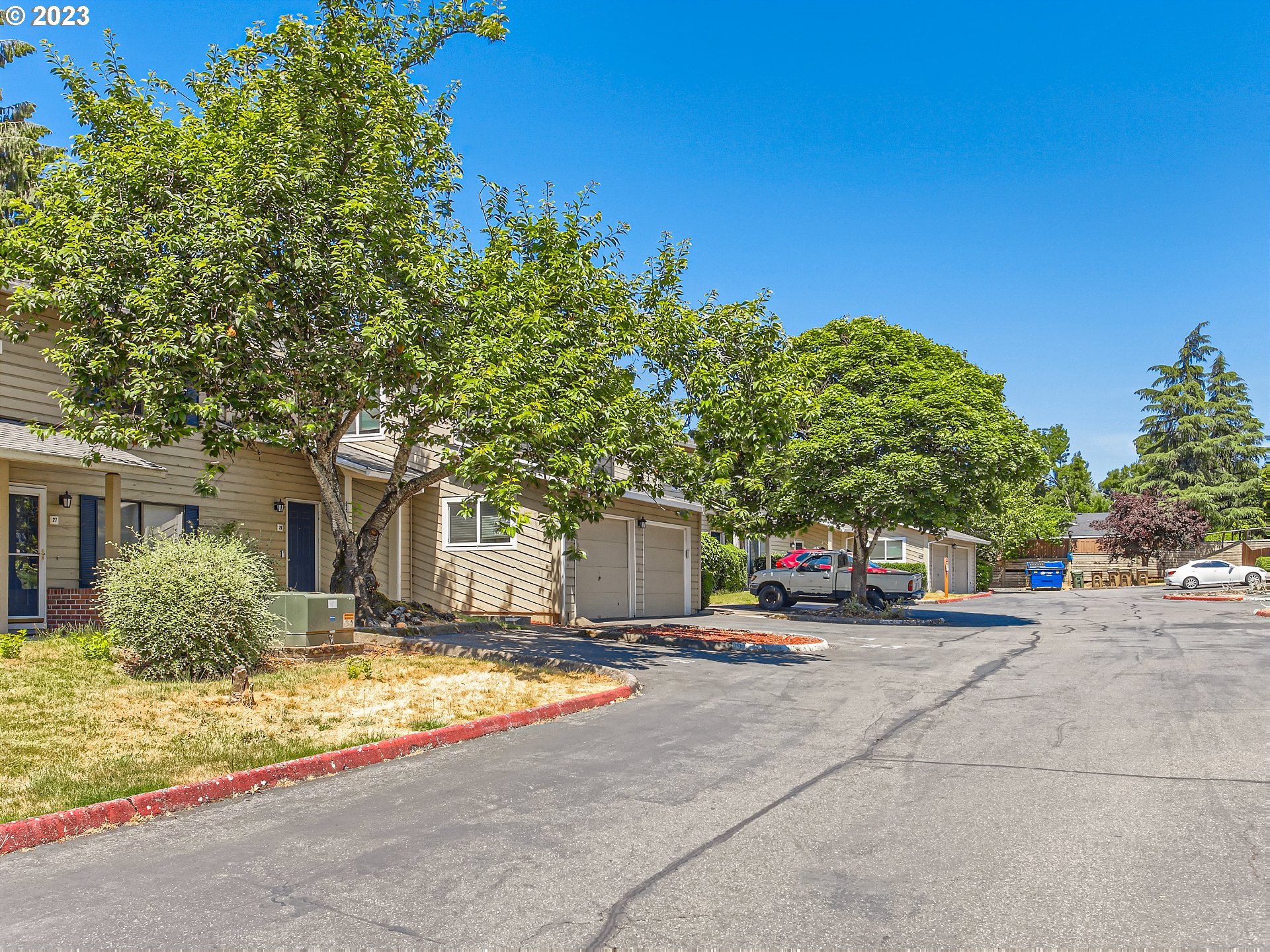 29530 Southwest Volley Street, Unit 30 Wilsonville, OR 97070 - Photo 23 of 29 a front view of a house with a yard and trees