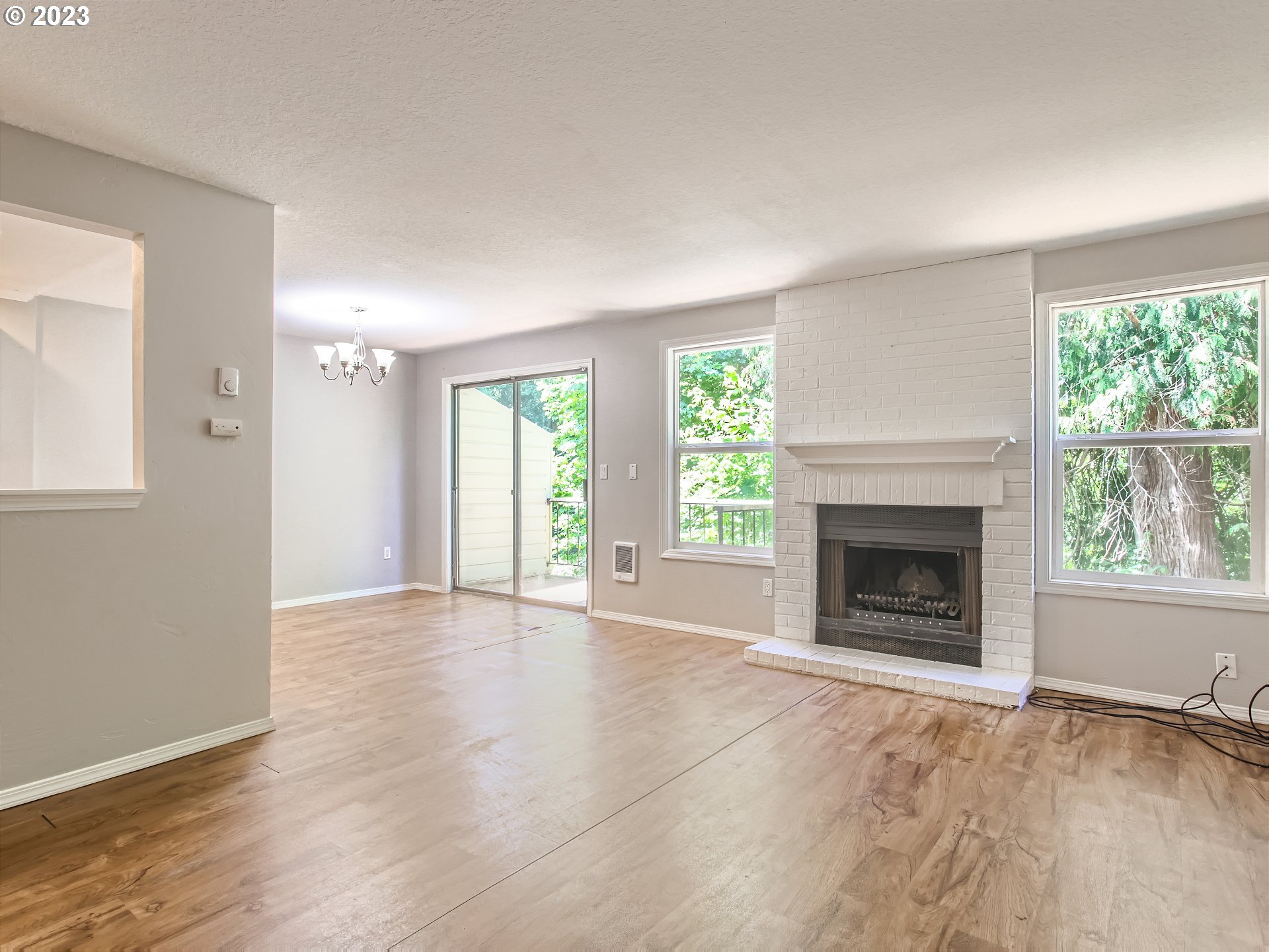 29530 Southwest Volley Street, Unit 30 Wilsonville, OR 97070 - Photo 4 of 29 an empty room with windows and a fireplace