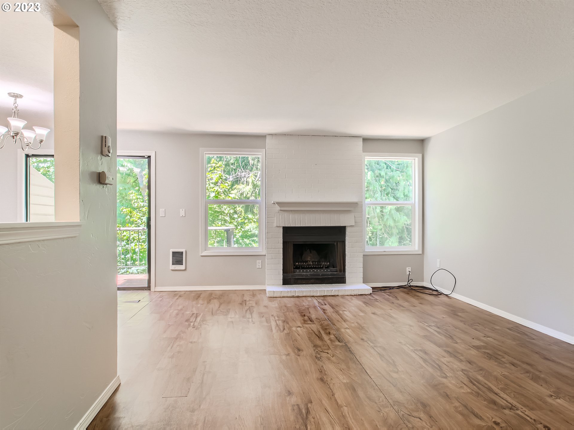 29530 Southwest Volley Street, Unit 30 Wilsonville, OR 97070 - Photo 5 of 29 an empty room with windows and fireplace