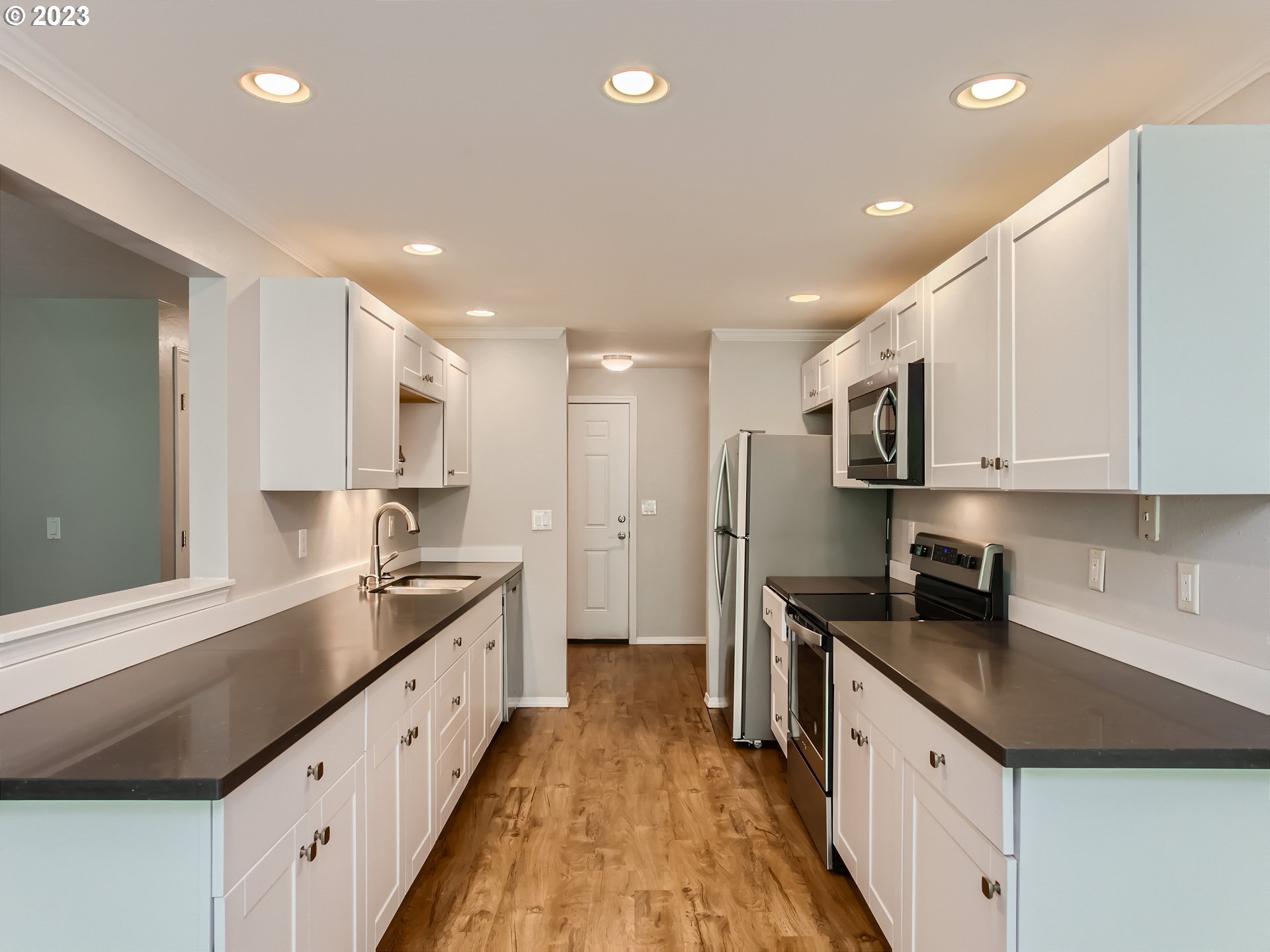 29530 Southwest Volley Street, Unit 30 Wilsonville, OR 97070 - Photo 8 of 29 a large kitchen with stainless steel appliances granite countertop a sink and cabinets