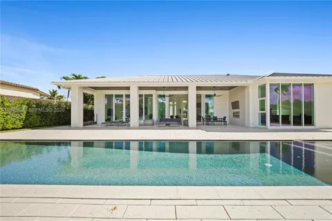 a view of a house with a backyard porch and sitting area