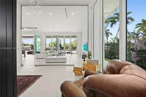a kitchen with stainless steel appliances kitchen island a stove a sink a refrigerator a center island and a stove top oven