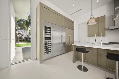 a kitchen with stainless steel appliances granite countertop a sink a stove and a wooden floors