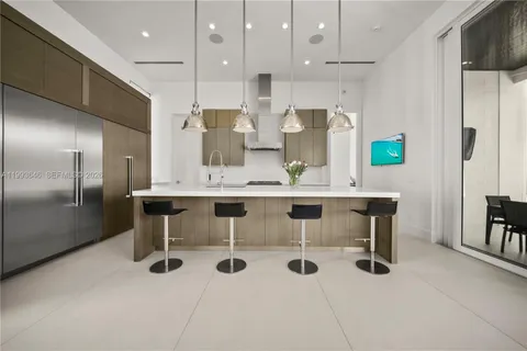 a kitchen with stainless steel appliances granite countertop a sink a stove and a refrigerator