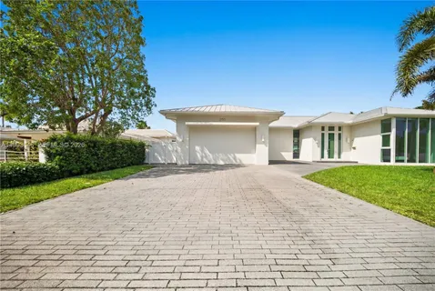 a front view of a house with a yard and a garage