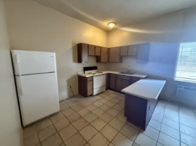 a kitchen with stainless steel appliances a refrigerator sink and cabinets