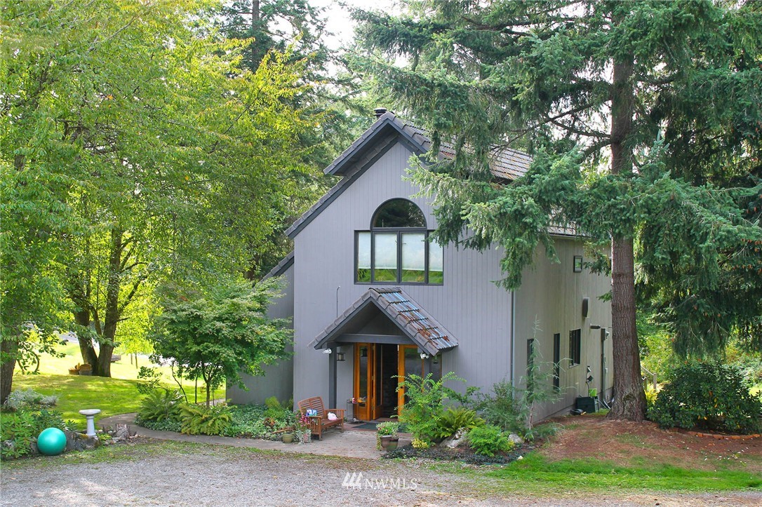 10649 Southwest Cedarhurst Road Vashon, WA 98070 - Photo 1 of 25 a front view of a house with garden