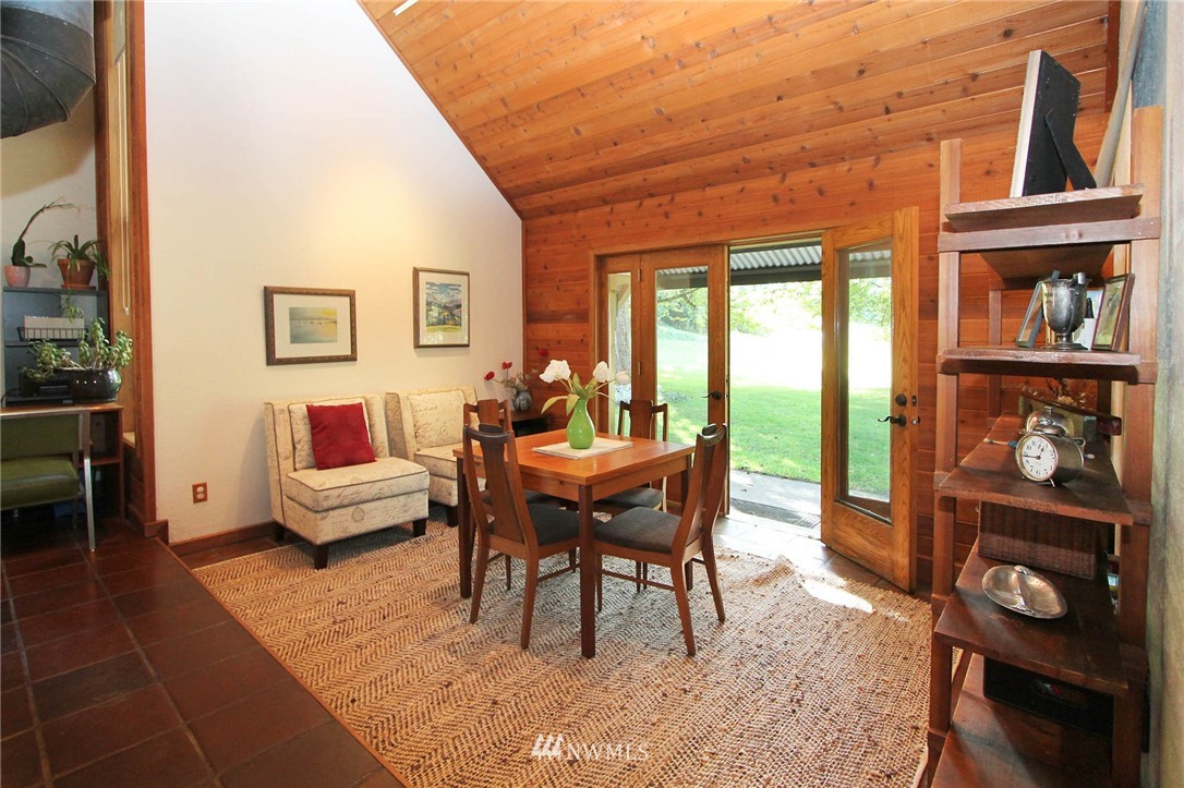 10649 Southwest Cedarhurst Road Vashon, WA 98070 - Photo 11 of 25 a living room with furniture a rug and a floor to ceiling window