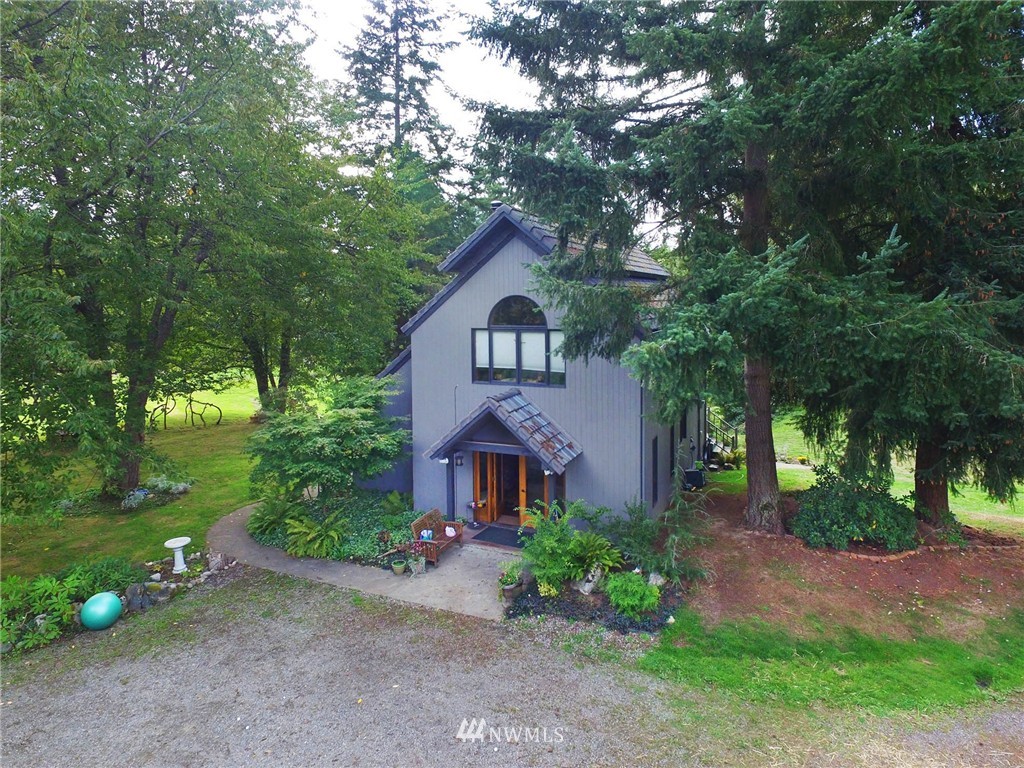 10649 Southwest Cedarhurst Road Vashon, WA 98070 - Photo 20 of 25 a front view of a house with garden
