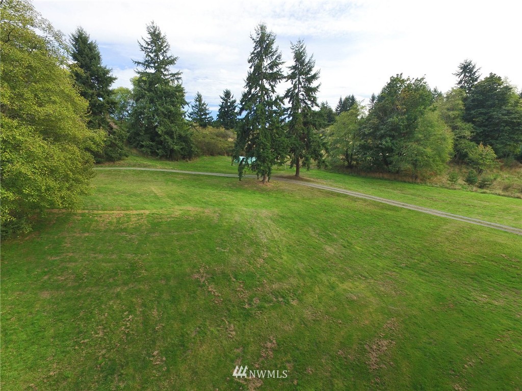 10649 Southwest Cedarhurst Road Vashon, WA 98070 - Photo 7 of 25 a view of a field of grass and trees
