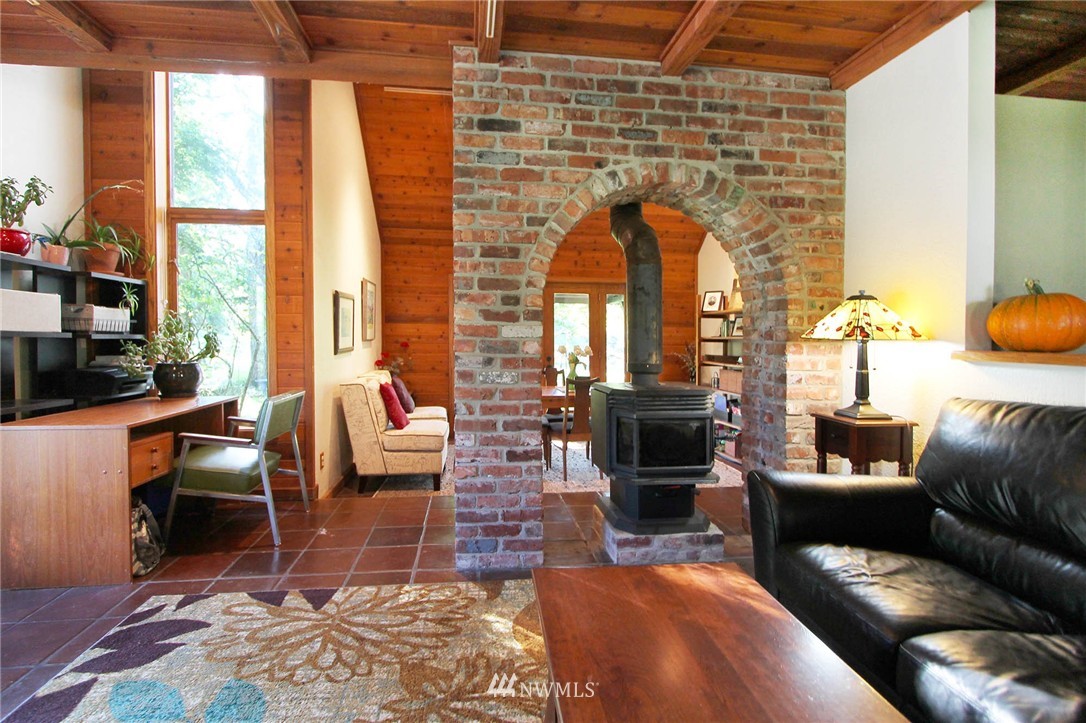 10649 Southwest Cedarhurst Road Vashon, WA 98070 - Photo 10 of 25 a living room with furniture and a fireplace