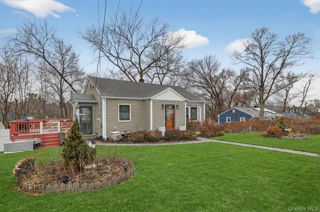 a front view of house with yard and green space