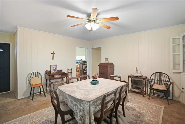 a view of a dining room with furniture and a chandelier