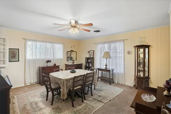 a view of a a dining room with furniture window and wooden floor