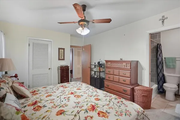 a bedroom with a bed and dresser