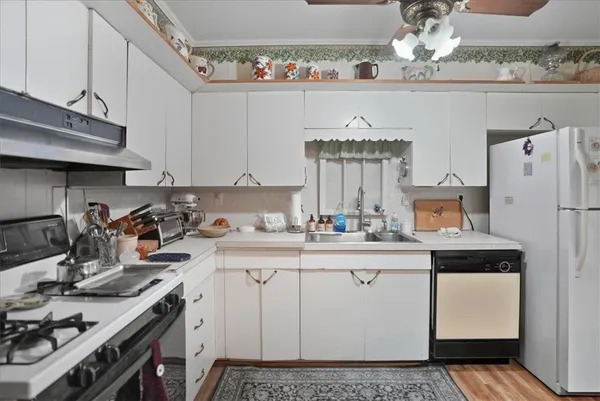 a kitchen with a sink a stove and cabinets