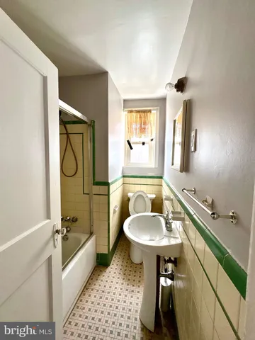 a bathroom with a sink a mirror and a bathtub