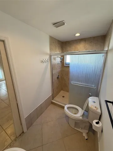 a bathroom with a toilet and a shower