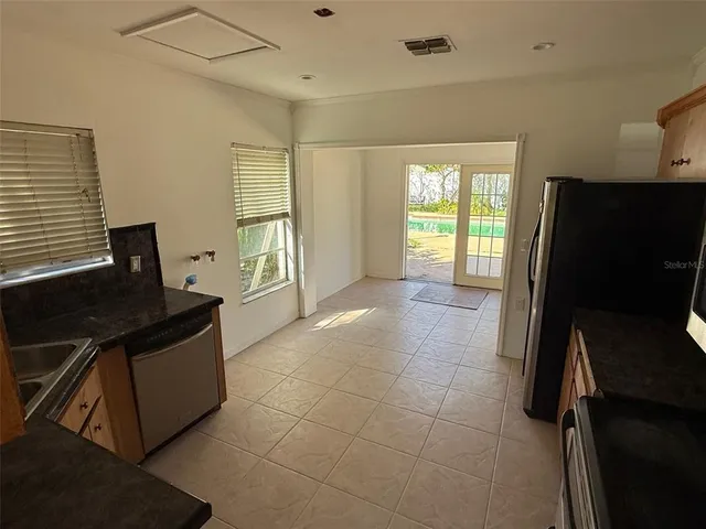 a kitchen with a stove top oven and sink