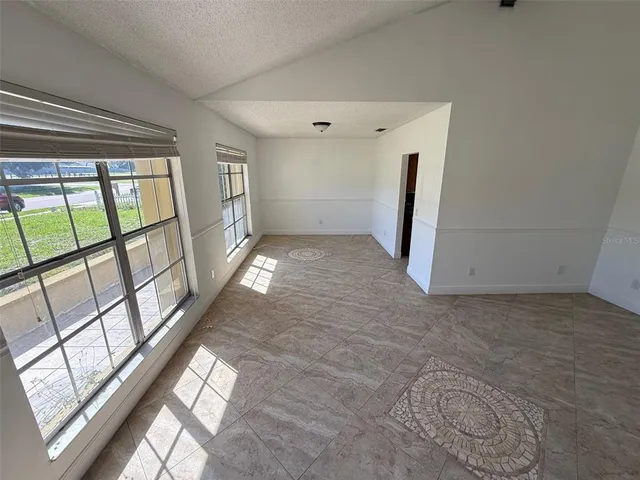 a view of an empty room and a window