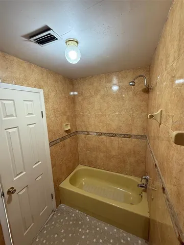 a bathroom with a shower and a tub