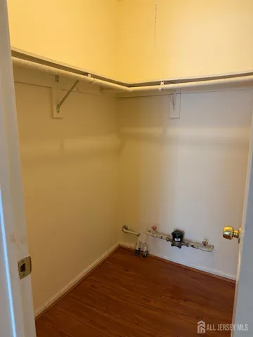 a room with a wooden floor and a window