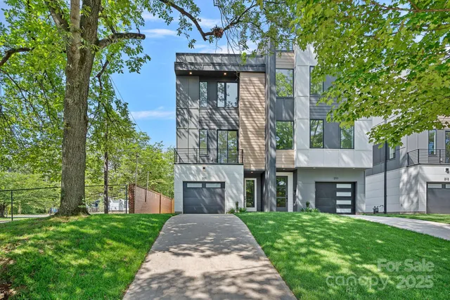 a front view of a house with a garden and plants