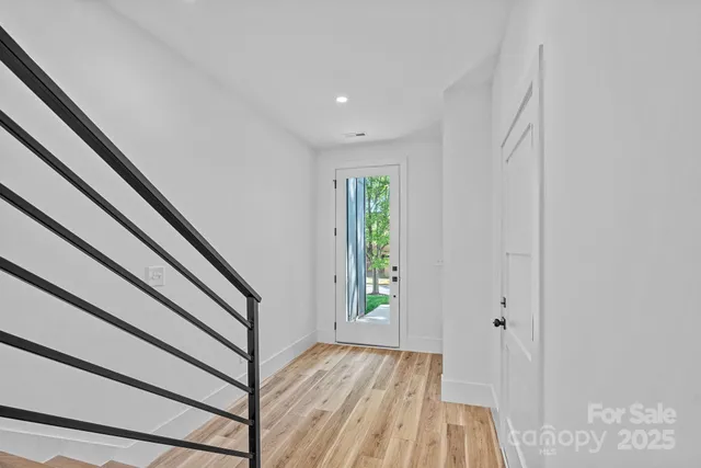 a view of a kitchen with a sink and wooden floor