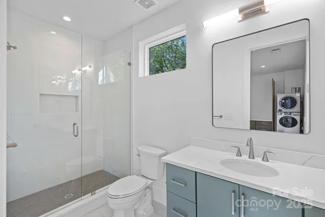 a view of kitchen island wooden floor windows and refrigerator