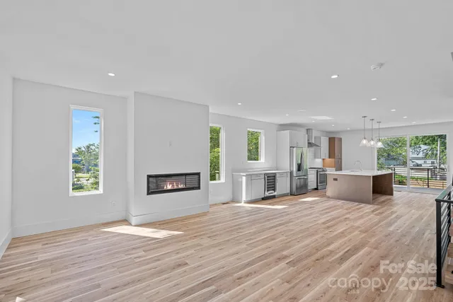 a view of a room with wooden floor and stairs