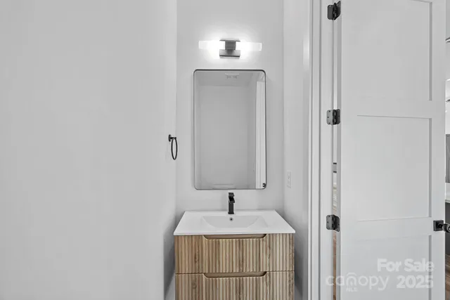 a view of a staircase with wooden floor and metal railing