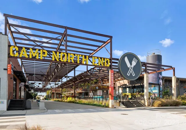 a dining room with stainless steel appliances kitchen island a table chairs and a kitchen view
