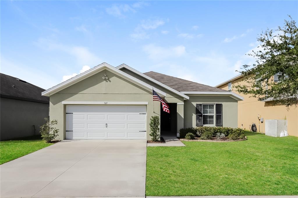 Undisclosed Address Spring Hill, FL 34609 - Photo 1 of 1 a view of a house with a yard and garage