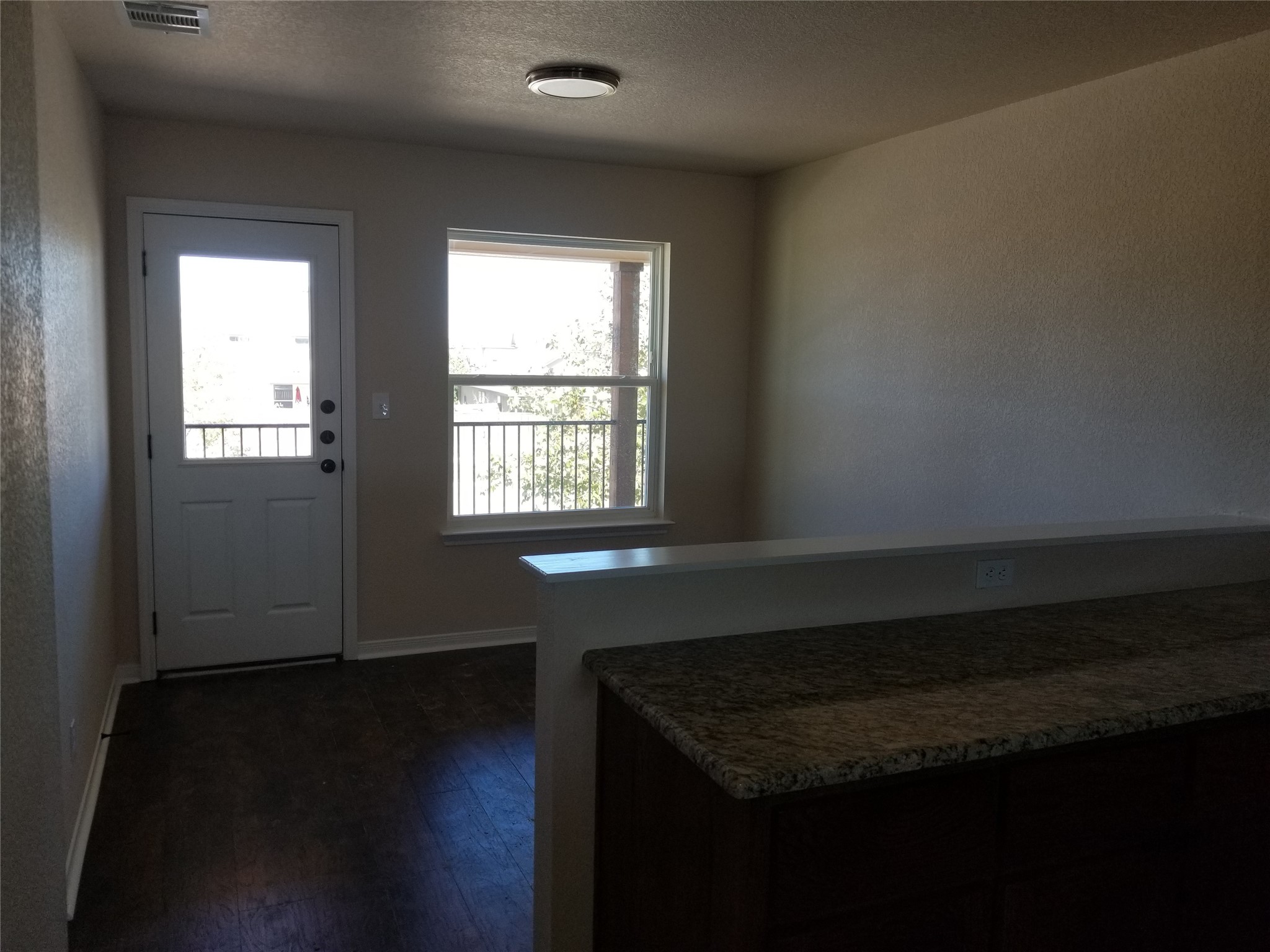 92 Sandstone Drive, Unit B Jarrell, TX 76537 - Photo 3 of 4 a living room with a wooden floor and a window