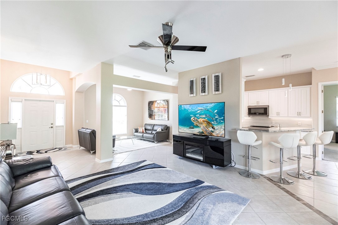 9013 West Ridge Court Fort Myers, FL 33912 - Photo 12 of 43 a living room with furniture a flat screen tv and a fireplace